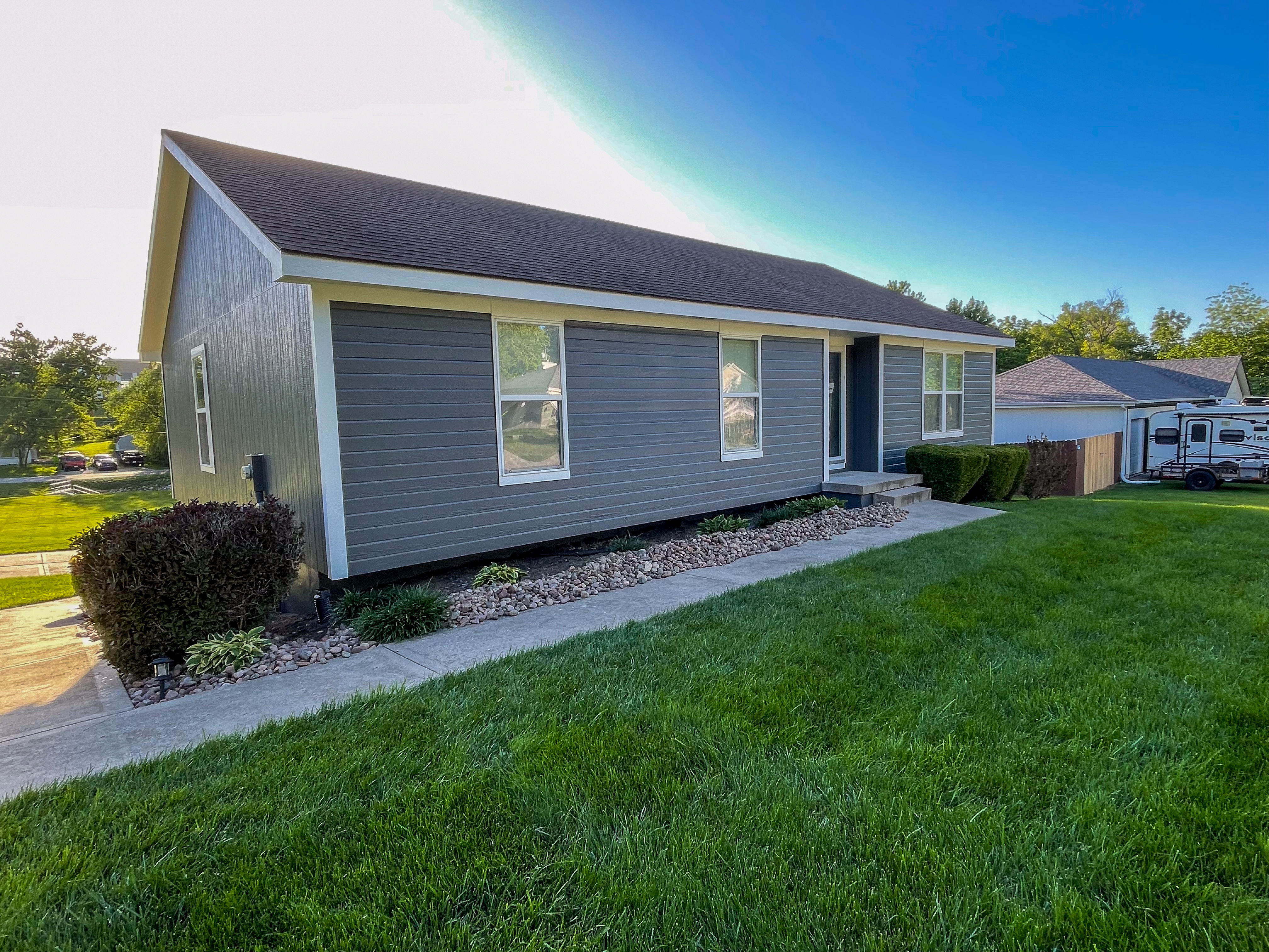 Freshly painted gray ranch-style house exterior in Grandview, MO by Red Letter Painting